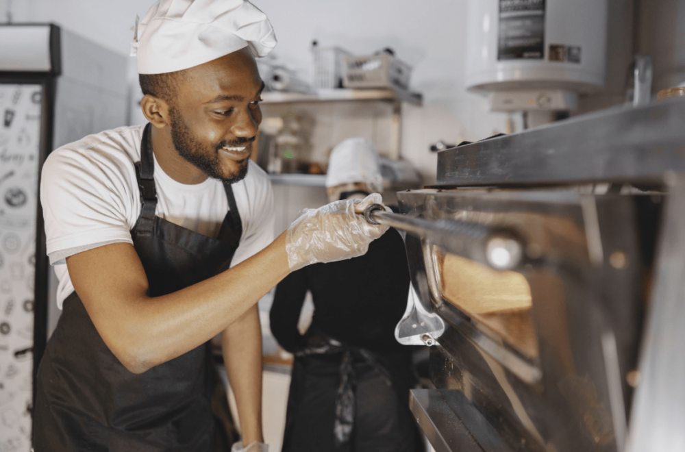 cook peeking into comercial oven