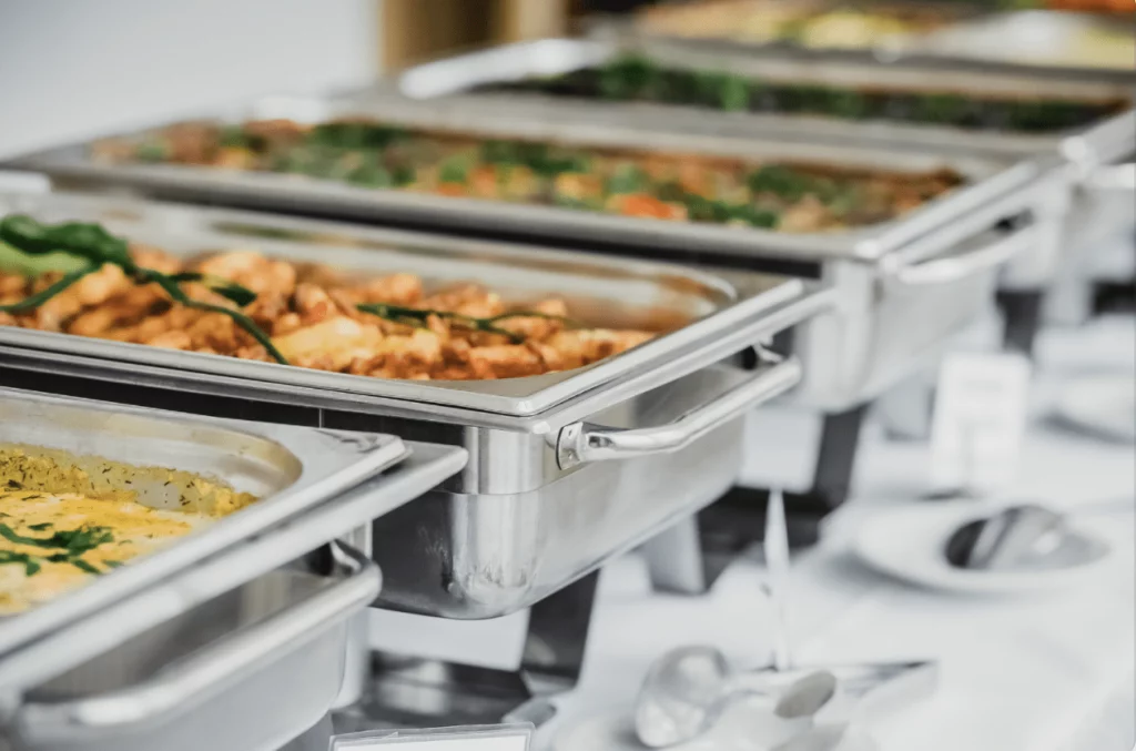 chafing dishes used by caterers on a buffet table